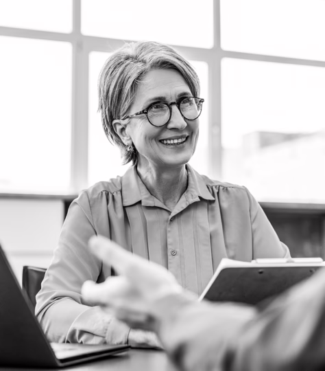 Woman holding documents smiling