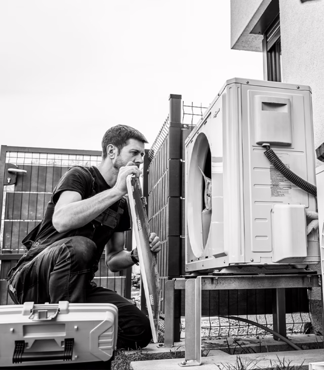 HVAC technician installing a heat pump.