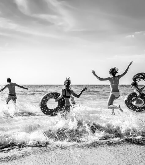 people running into ocean