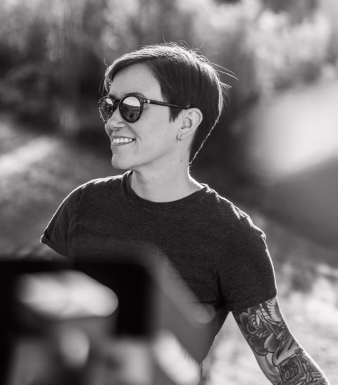 woman with sunglasses smiling while looking into the distance